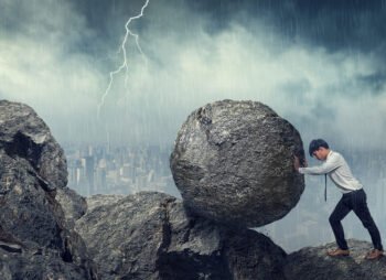 Business man pushing large stone up to hill , Business heavy tasks and problems concept.